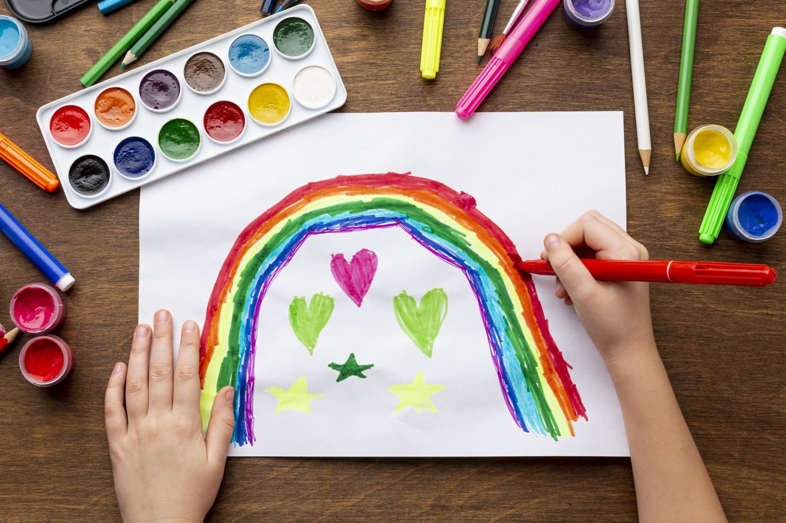 A child drawng a rainbow